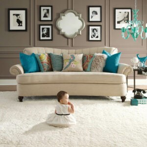 Cute baby sitting on carpet floor | CarpetsPlus of Steamboat Springs